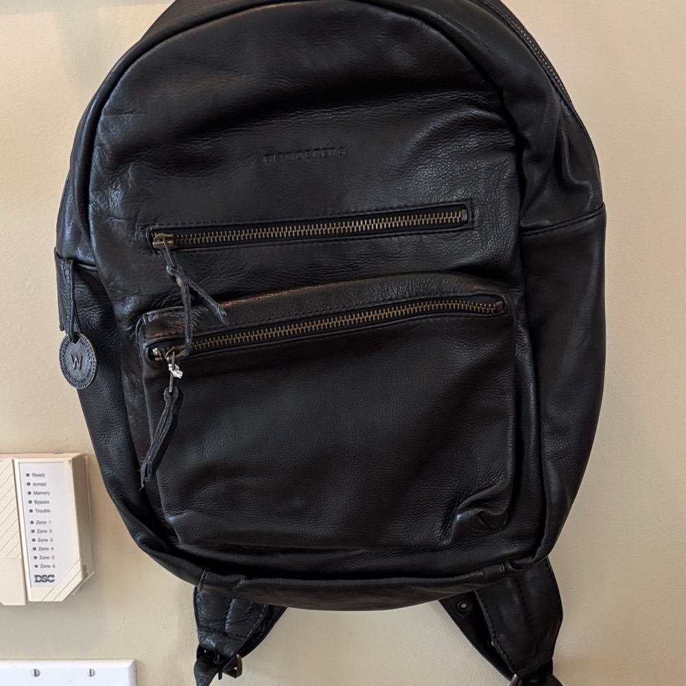 WANDERERS Travel Co. Black Leather Backpack with Front and side zip pocket.